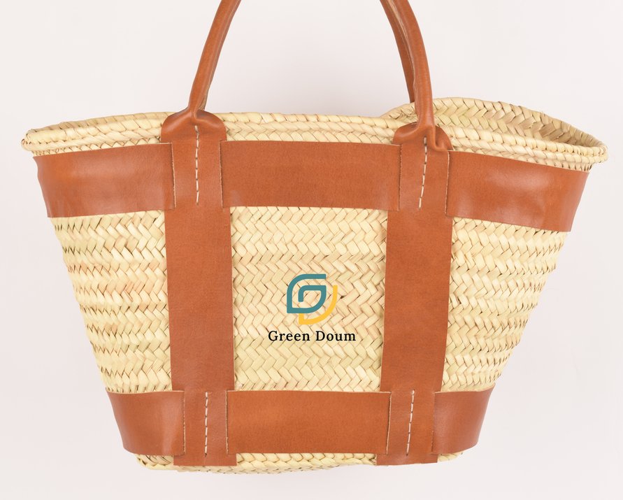 Straw tote with leather bands by Green Doum